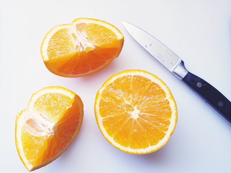 sliced juicy orange on a cutting board DearCreatives.com