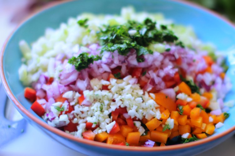 Close up of a pasta salad topped with copped vegetables ready to be mixed for a vegetarian pasta salad recipe © 2018 DearCreatives.com