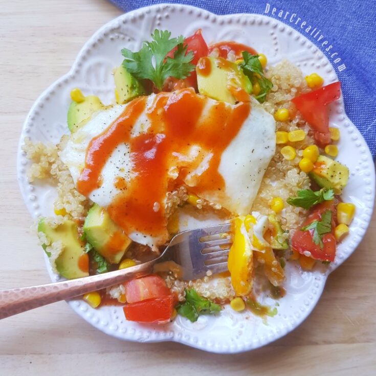 Southwest quinoa egg breakfast bowl with a fork in food, ready to eat the breakfast bowl. DearCreatives.com