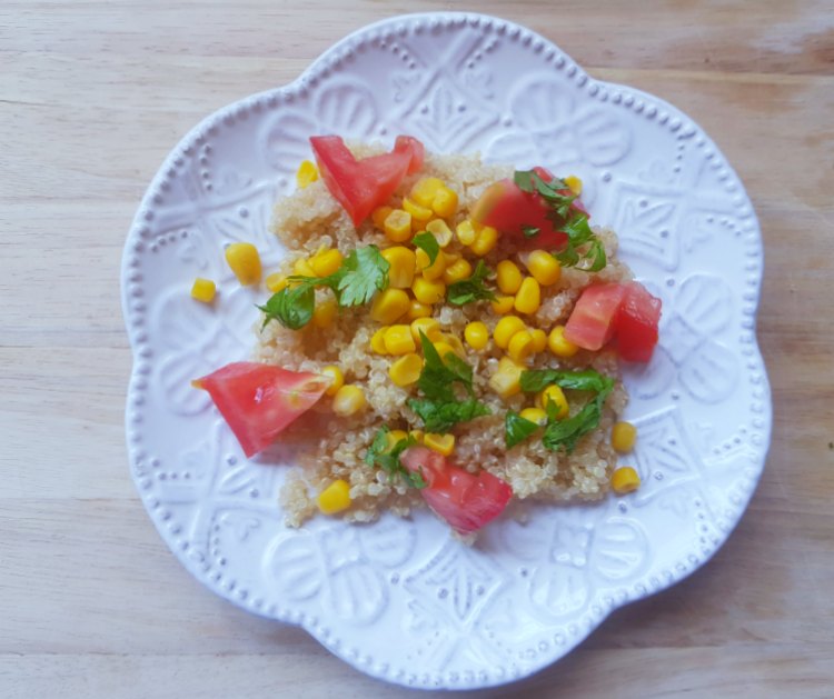 Tomatoes, corn, cilantro on top of quinoa for a Southwest breakfast recipe Dearcreatives.com