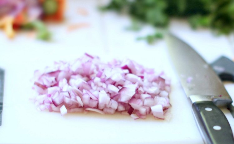 chopped purple onion for a pasta salad on a cutting board for a vegetarian salad DearCreatives.com