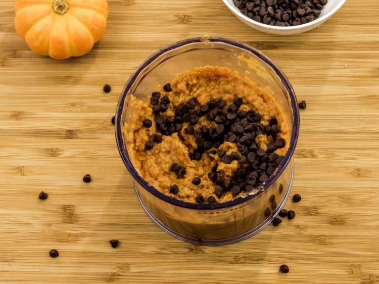 Adding Chocolate Chips to the pumpkin batter for pumpkin donuts. DearCreatives.com