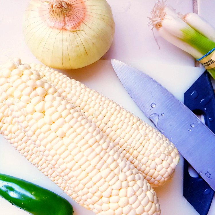 Corn on the cob, jalapeno, onion, green onion, a cutting board for making a soup recipe DearCreatives.com