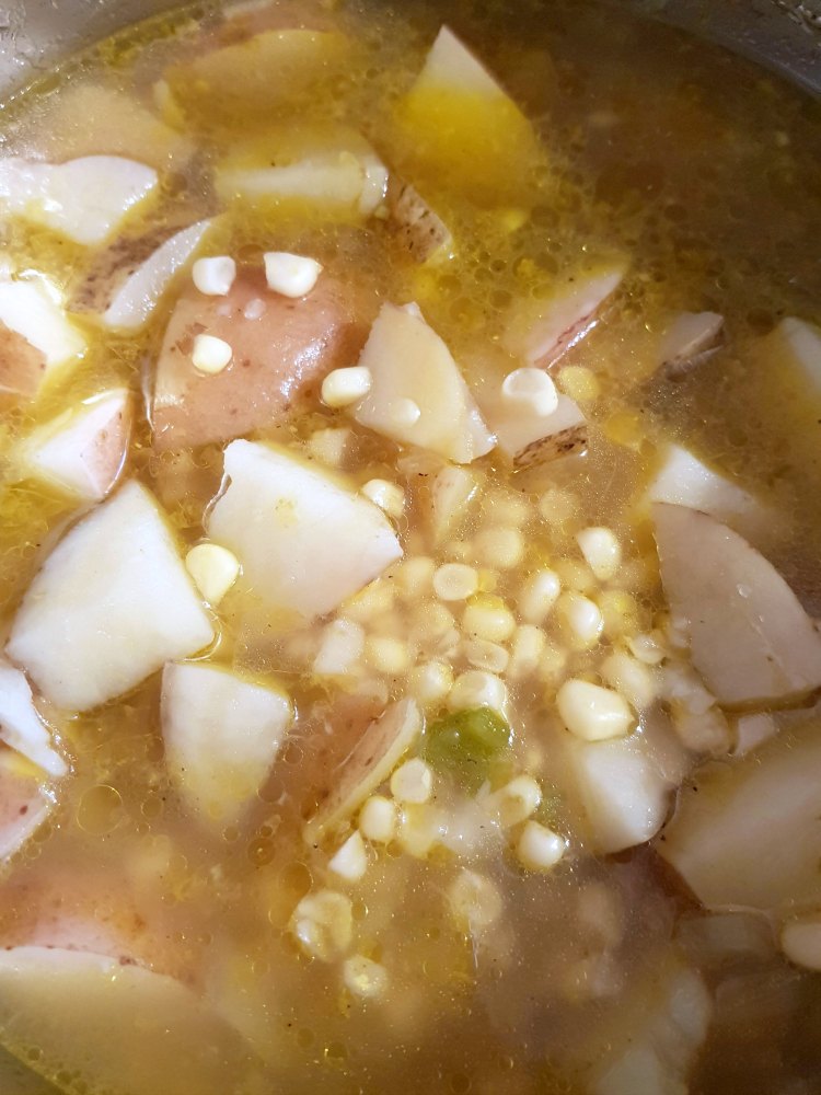 Your potato corn chowder soup will look like this vegetable broth, corn, potatoes, sauteed veggies all in the pot cooked ready for final step. DearCreatives.com