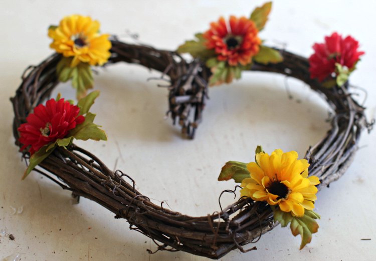 fall flowers hot glued to the grapevine wreath see full tutorial how to make a fall wreath at DearCreatives.com