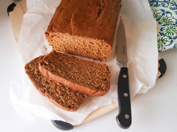 Close up of slices of pumpkin bread on a cutting board with a knife that just sliced the loaf of pumpkin spice bread. Grab the pumpkin bread recipe at DearCreatives.com