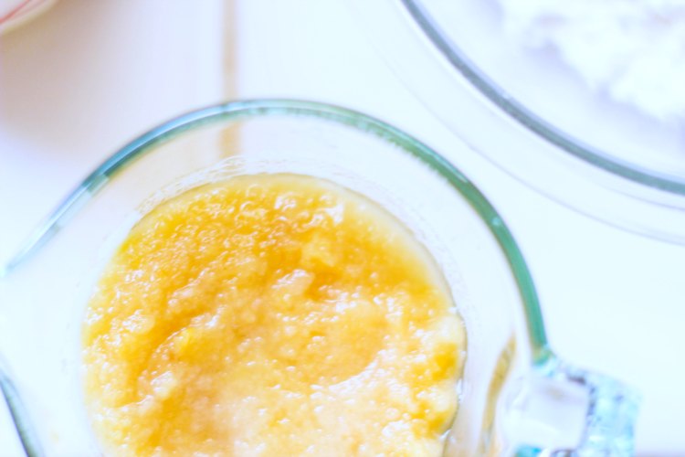 Pumpkin puree in a measuring cup, and flour in a mixing bowl. Baking pumpkin recipes. DearCreatives.com