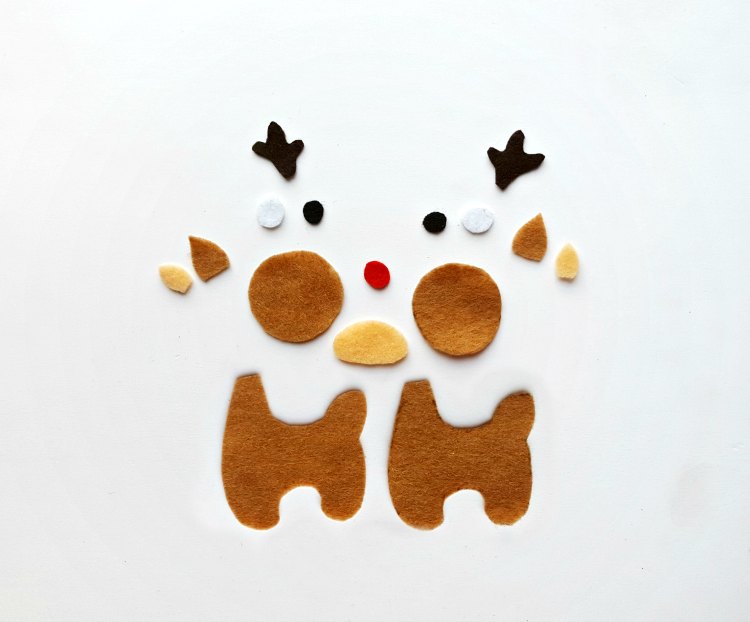 felt pieces cut out to make a reindeer ornament. Christmas ornament diy and directions at DearCreatives.com #deer #felt #reindeer #Rudolph #crafts