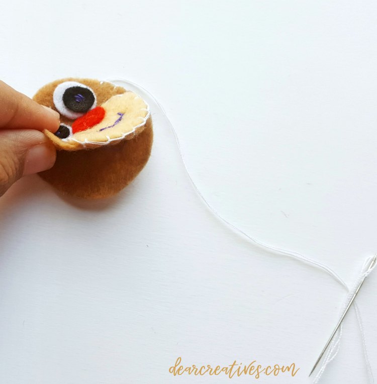 step (6) piecing the top of the reindeer face to the back of the head to embroider it together for the reindeer ornament. DearCreatives.com