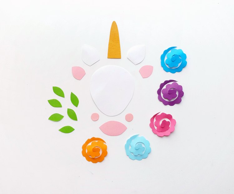 unicorn template printed and paper craft cut out in colored papers ready to be assembled step (1) DearCreatives.com #unicorncraft #papercraft #diy #unicorn #template
