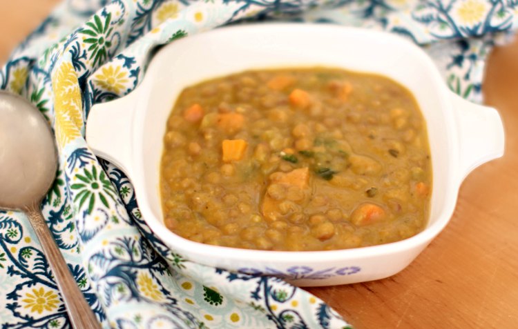 lentil soup in a bowl with a pretty cloth napkin and soup spoon. Lentil Soup Recipe at DearCreatives.com