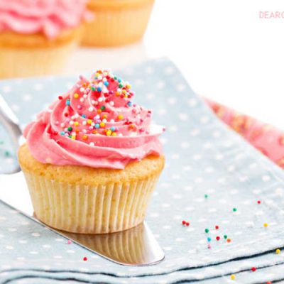 Vanilla Cupcakes with pink frosting and colorful sprinkles