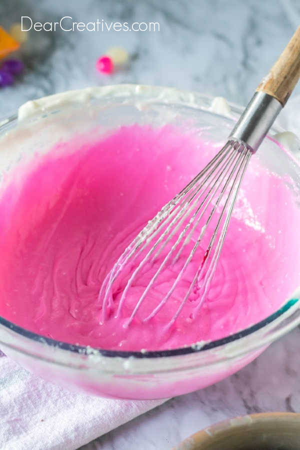 Added food coloring to the batter of the cake to create the color of the cake layer. Theme colors or gender reveal cake colors can vary with every layer in the cake. How to at DearCreatives.com
