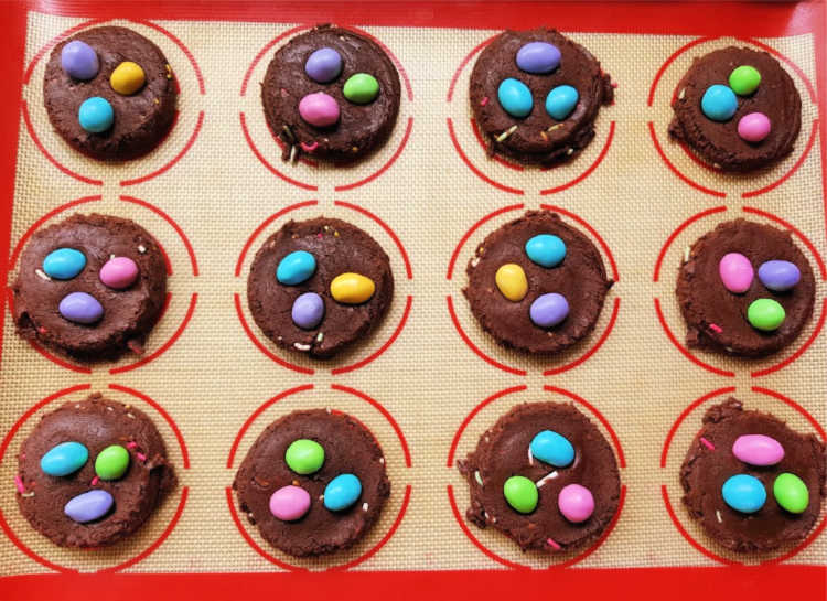 Brownie Cookies with Chocolate Candies on a baking sheet ready to be baked. Recipe at DearCreatives.com