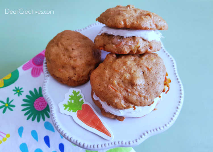 Carrot Cake Cookies and Carrot Cake Frosted Cookies on a cookie stand. Recipe at DearCreatives.com