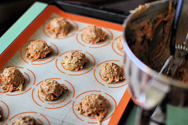 Cookie sheet with carrot cookies all scooped onto the baking mat ready to be baked in the oven. Recipe for carrot cake cookies at DearCreatives.com