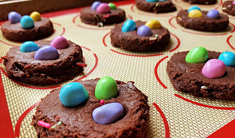 close up of un cooked brownie cookies with chocolate chip cookies with peanuts on tops. recipe at DearCreatives.com