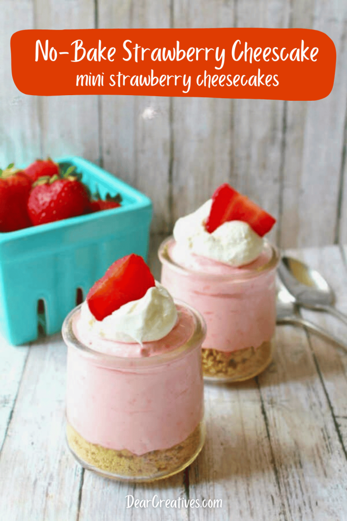 No-bake strawberry cheesecake mini desserts in mason jars with creamy layers, topped with fresh strawberries, served beside a basket of fresh strawberries for summer parties.
