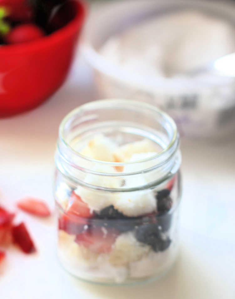 layering the red, white and blue dessert in a jar. See full directions at DearCreatives.com