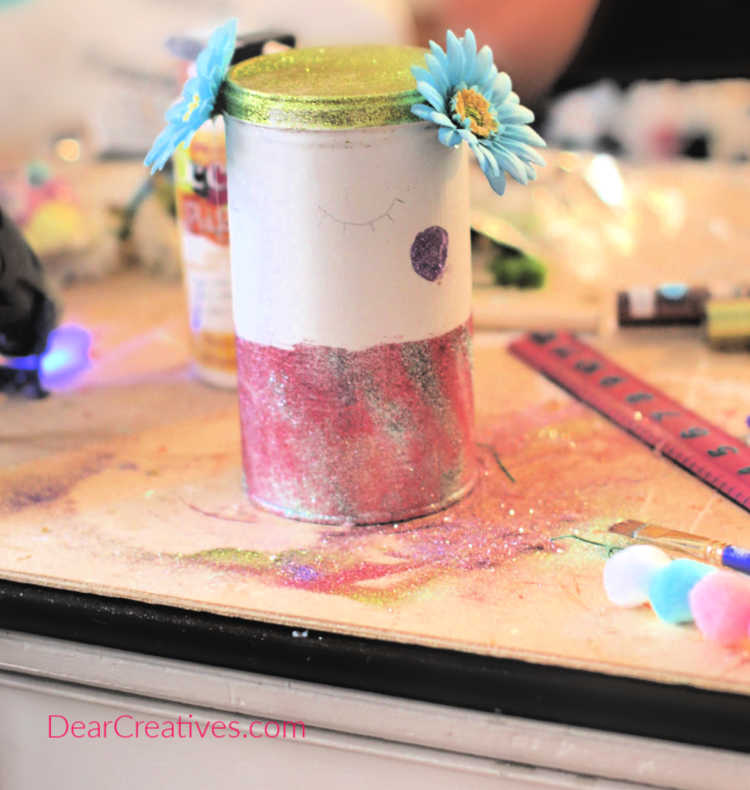 Begin to glue on the faux flowers to your can or jar. Unicorn DIY at DearCreatives.com