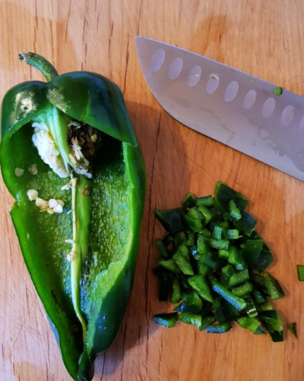 Cutting poblano peppers for making stuffed peppers. Dinner recipe at DearCreatives.com