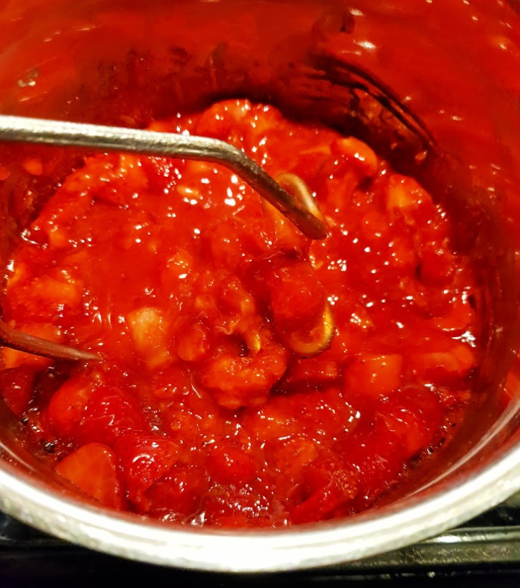 Strawberries being mashed for homemade strawberry jam. DearCreatives.com