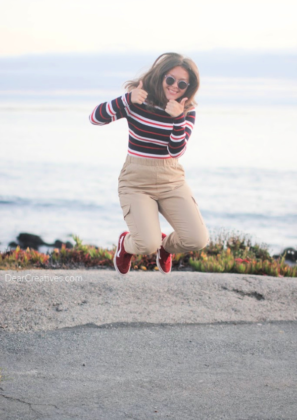 Young lady jumping for joy - wearing cute sunglasses... DearCreatives.com