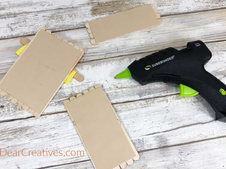 Attach each base group of wooden craft sticks to tan cardstock with a glue gun, trim excess cardstock with scissors... DearCreatives.com