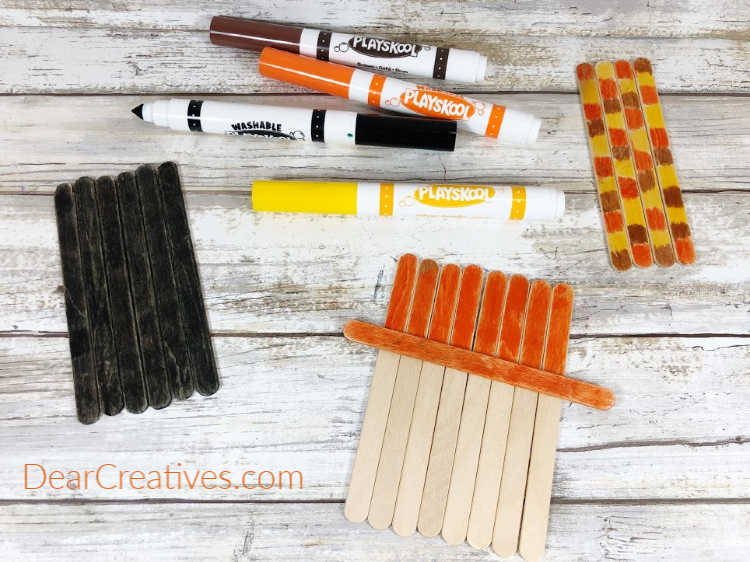 Step 1 - Assemble craft sticks, color small sections with orange, yellow and brown washable markers... DearCreatives.com