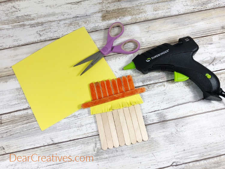 Step 3 - Cut and fringe a rectangle of yellow craft foam, glue to the top of scarecrow’s face... DearCreatives.com