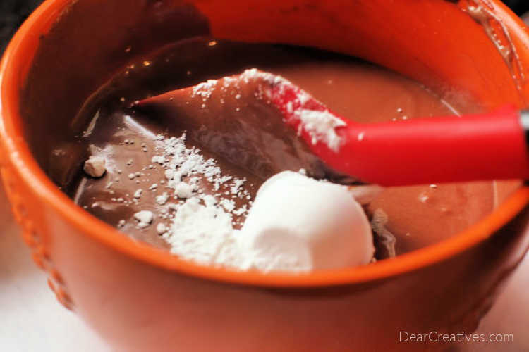 Adding confectioners sugar to melted chocolate for a Chocolate Cream Pie © DearCreatives.com