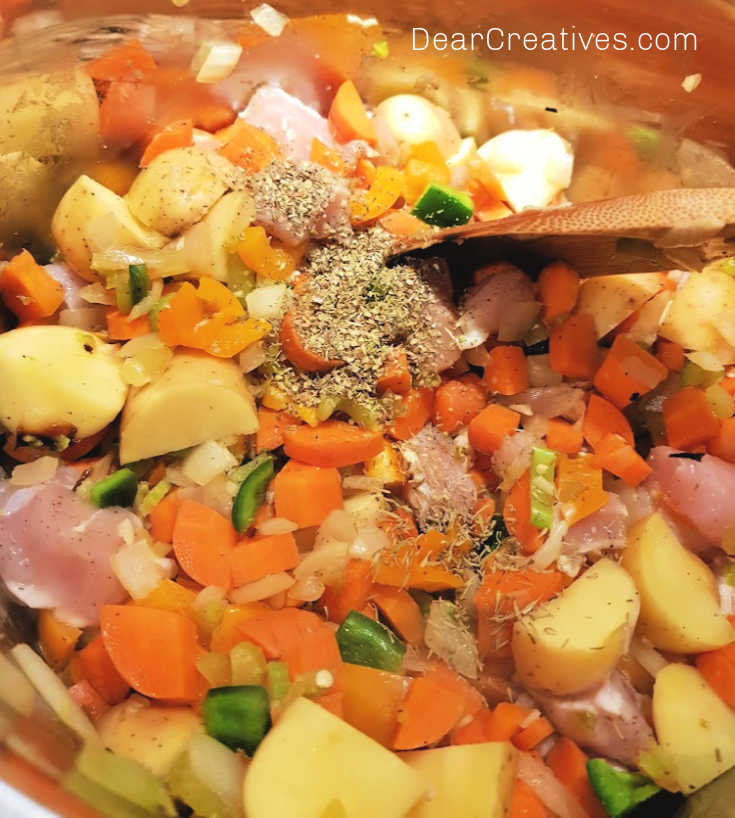 Cooking lemon chicken soup - Adding spices to the chicken soup recipe with lemon. Easy lemony chicken soup recipe at DearCreatives.com
