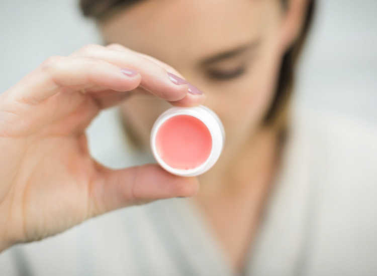 Holding-round-white-and-pink-lip-balm- DIY Lip Balm - DearCreatives.com