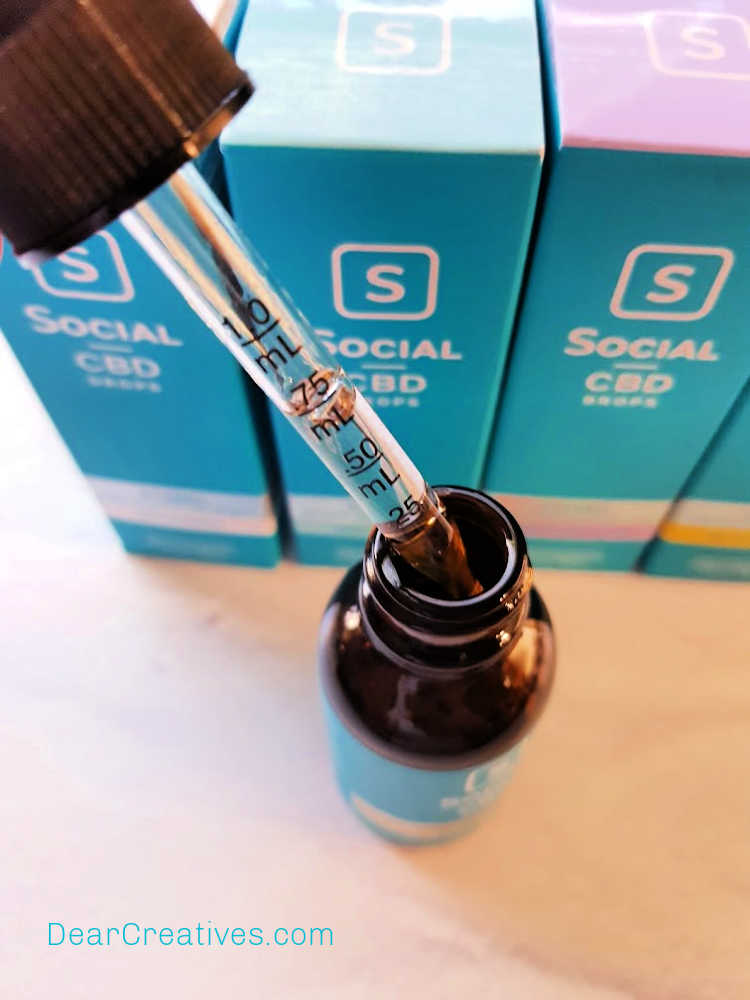 CBD oil bottle and dropper close up - CBD oil what is it_ how is it used_ how it helps relax you...DearCreatives.com