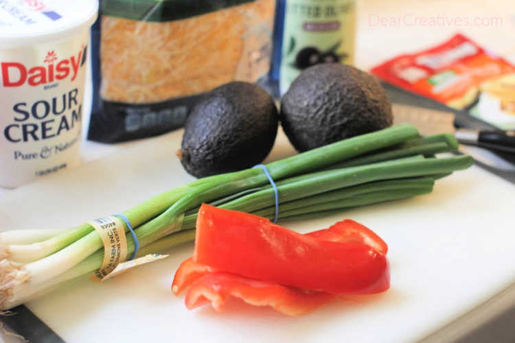avocado, black olives, cooking, Food, green onions, ground beef, ingredients for taco stuffed potatoes, lime, potatoes, red bell peppers, shredded cheese, sour cream, taco potatoes, taco potatoes recipe, taco seasoning, taco stuffed potatoes, taco potatoes stuffed with ground beef, potatoes stuffed with ground beef, potatoes stuffed with ground beef and taco toppings, 30-minute meal, 1-hour meal, fresh, tasty, filling, healthy, dinner, lunch, recipe, 