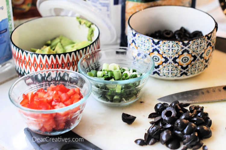 Prepping toppings for taco potatoes © DearCreatives.com