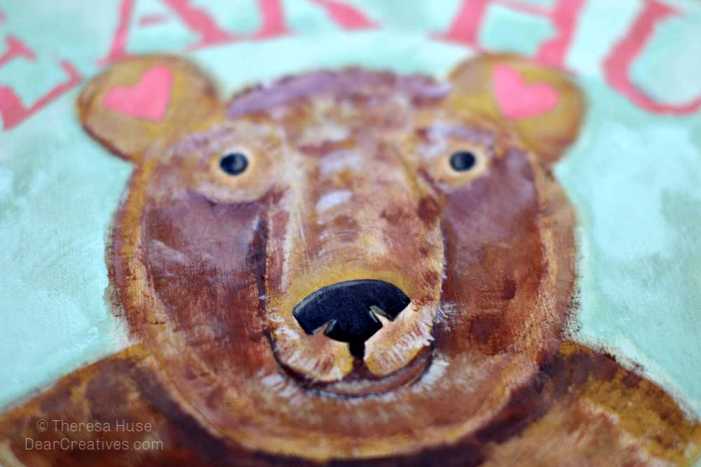 Detailing-bear-face-with-black-nose-eyes-and-toffee-highlights. Acrylic paint step by step how-to paint a cute bear face. DearCreatives.com