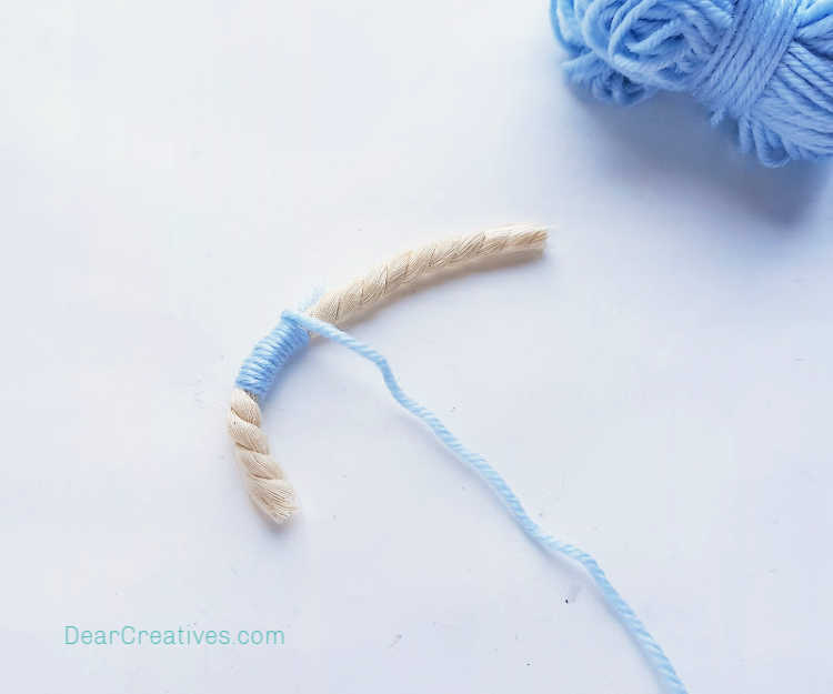 step (3) wrapping the yarn around the rope. How-to make a macrame rainbow at DearCreatives.com