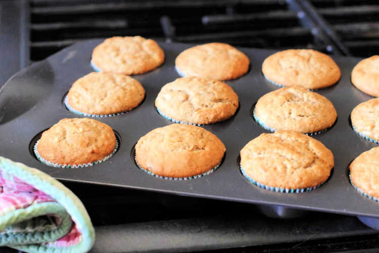 banana muffins batter scooped into muffin lined muffin pan - © DearCreatives.com 