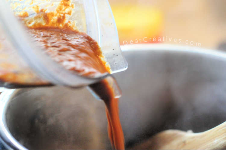 adding adobo - chipotle sauce to Instant Pot to cook beef barbacoa - © DearCreatives.com