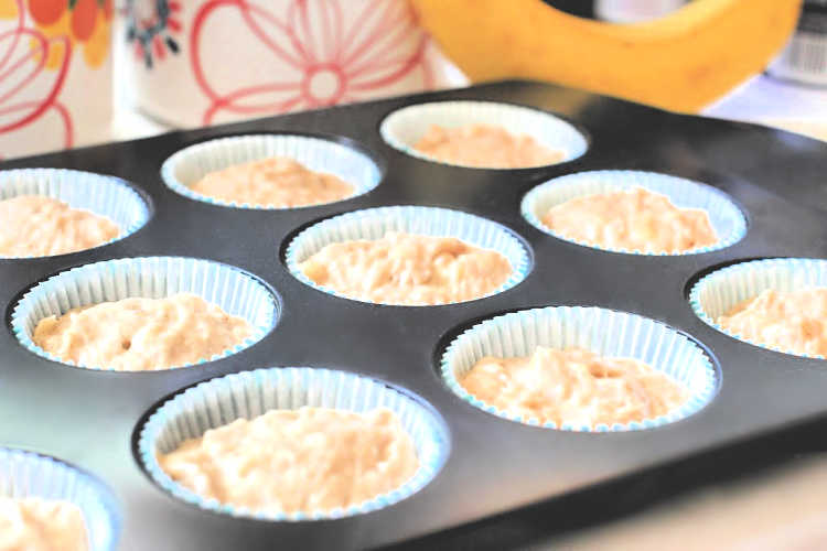 banana muffins batter scooped into muffin lined muffin pan - © DearCreatives.com 