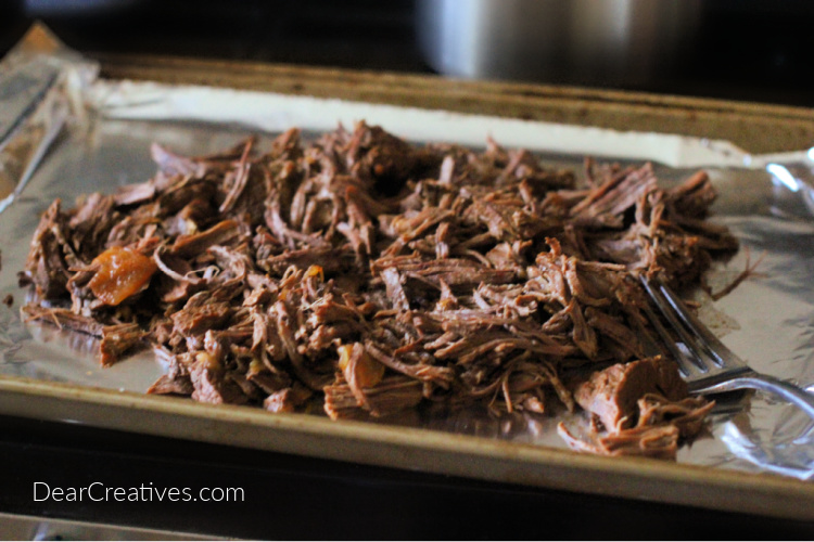 beef barbacoa on a covered sheet pan before sauce is added to be broiled - © DearCreatives.com