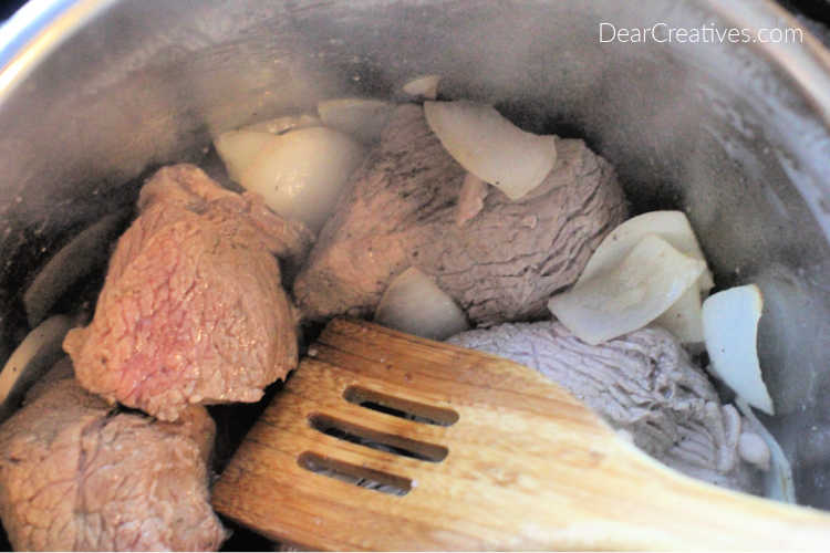 beef in an Instant Pot being braised for making beef barbacoa - DearCreatives.com