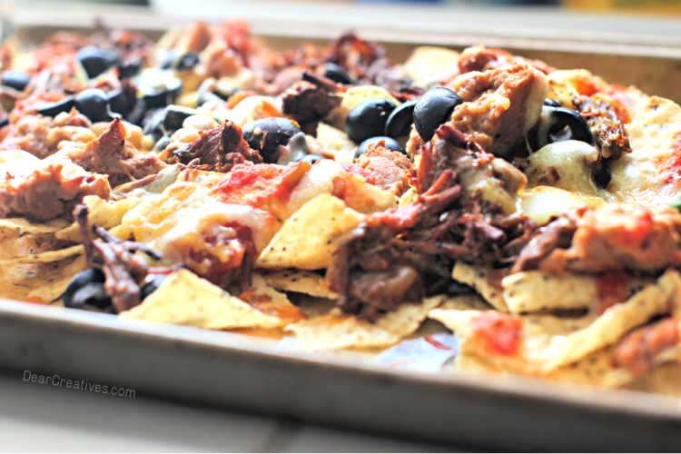 beef nachos - sheet-pan beef nachos made with shredded beef, beans, cheese, olives, salsa...© DearCreatives.com