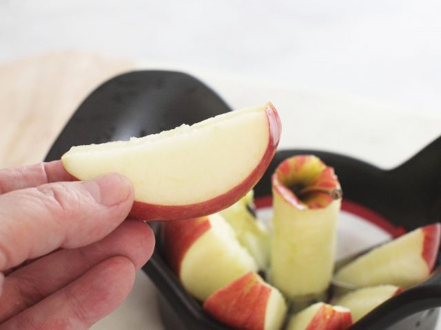 healthy snack - sliced apple -apple slicer with an apple in it and holding a sliced apple © DearCreatives.com
