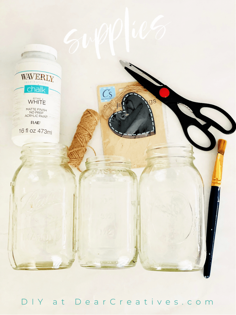 supplies for a mason jar craft -mason jars, chalk paint, twine, heart tags, paintbrush, scissors - See DIY at DearCreatives.com