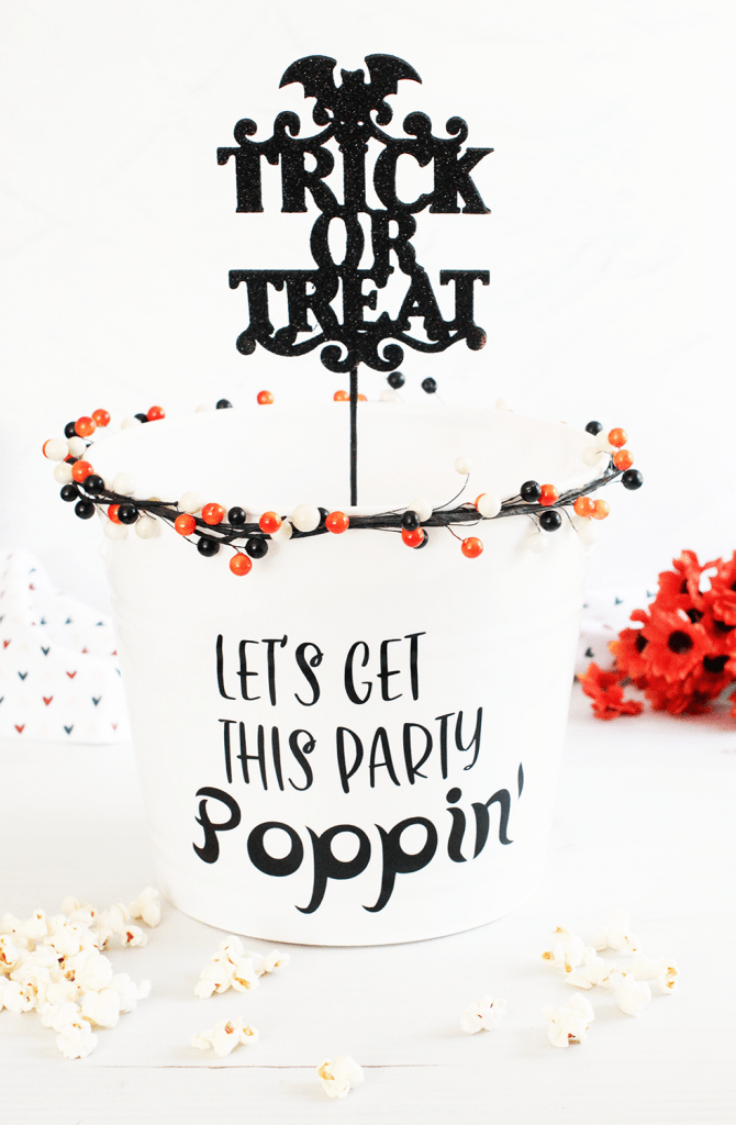 DIY Halloween Treat Bucket - Let's Get This Party Poppin' Plastic bucket, garland, trick or treat pick, vinyl stickers... Halloween Ideas © DearCreatives.com