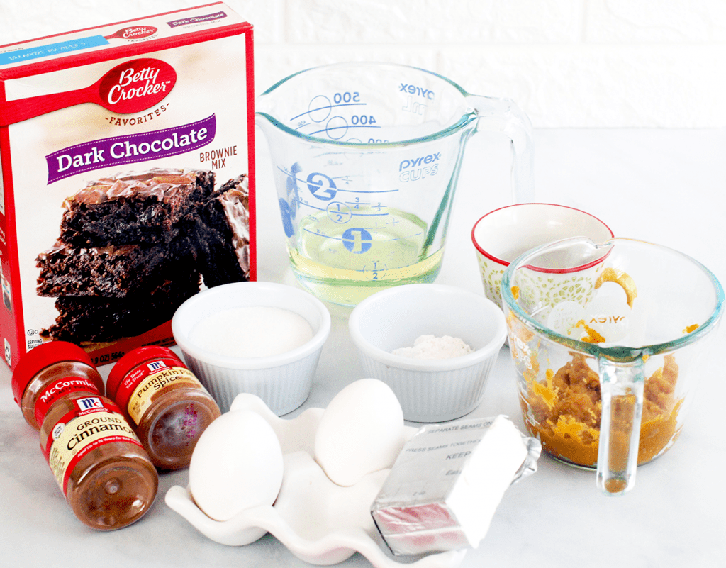 Pumpkin Brownies ingredients - Brownie Mix, eggs, vegetable oil, softened cream cheese, cinnamon, pumpkin spice, flour, pumpkin puree... Get the recipe for pumpkin brownies with pecans at © DearCreatives.com
