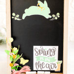 DIY Spring Chalkboard - This is an easy chalkboard art idea. Using stickers made with a Cricut (or purchased), artificial flowers, and a chalkboard. See how to decorate a chalkboard for spring! Find this and other DIY home decor ideas at DearCreatives.com