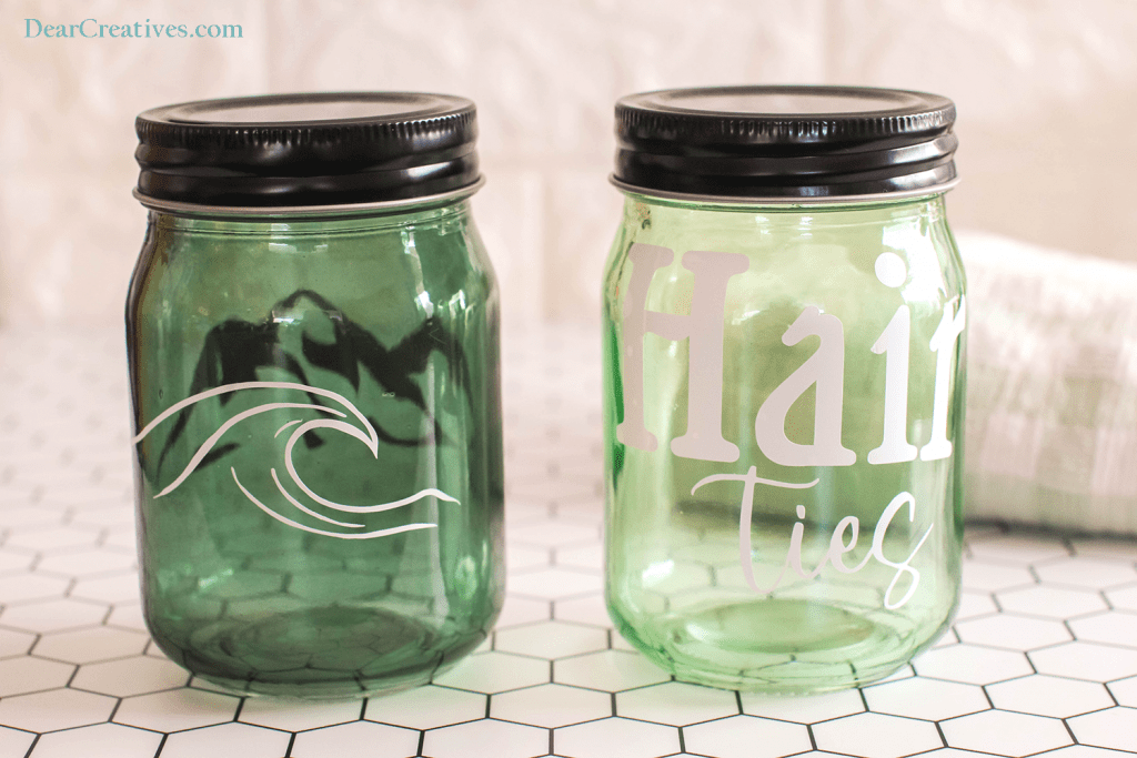 Cricut Jar Ideas - Jar with a wave design on one side and mountain design on the other. A jar with hair ties design. DIY at © DearCreatives.com